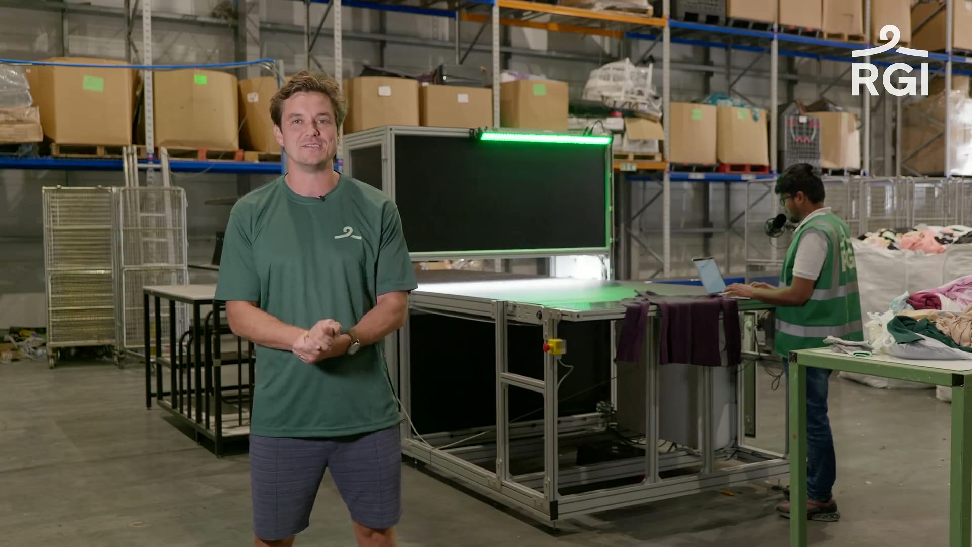 John Roberts beside RGI’s AI textile sorting machine at the company’s recycling facility.